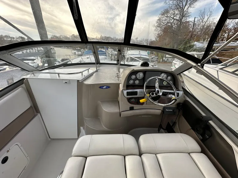 Slide: The Image of 2007 Four Winns 258 Vista boat cockpit with steering wheel and dashboard. - 14