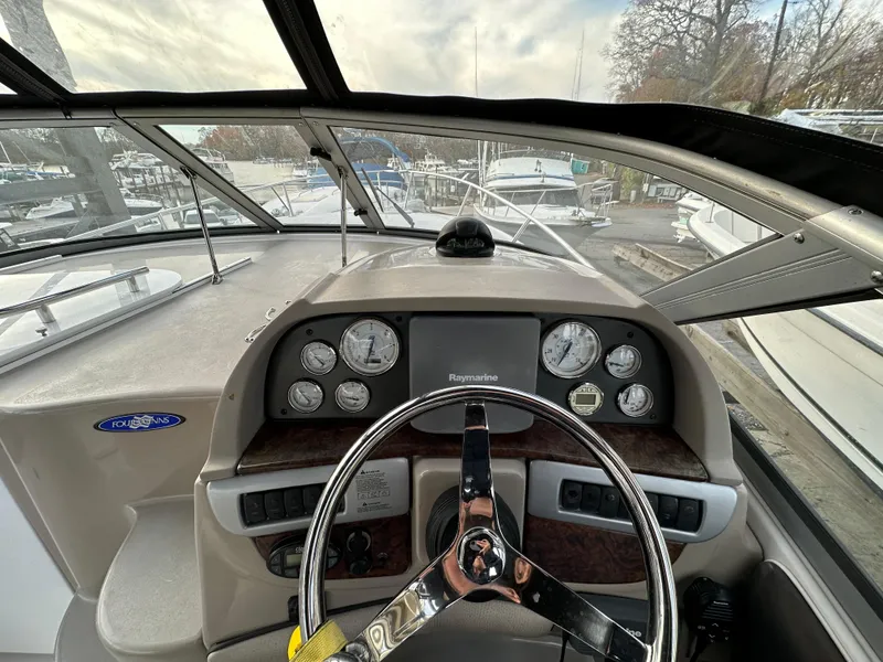 Slide: The Image of 2007 Four Winns 258 Vista boat dashboard with steering wheel and instrument panel. - 16