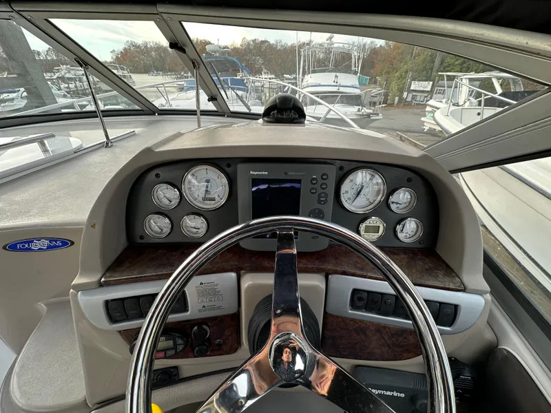 Slide: The Image of 2007 Four Winns 258 Vista boat dashboard with gauges and steering wheel. - 17