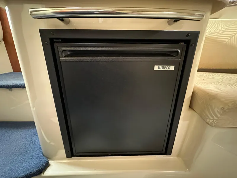 Slide: The Image of Compact Waeco refrigerator in 2007 Four Winns 258 Vista boat interior. - 25