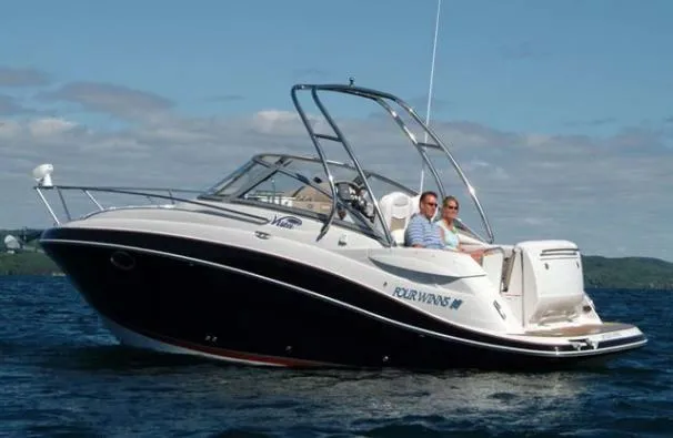 Slide: The Image of 2007 Four Winns 258 Vista boat on water with two people onboard. - 34