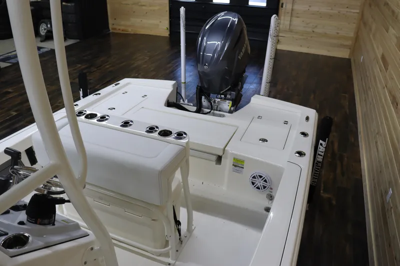 Slide: The Image of 2024 Pathfinder 2200 TRS boat interior with outboard motor in showroom. - 10