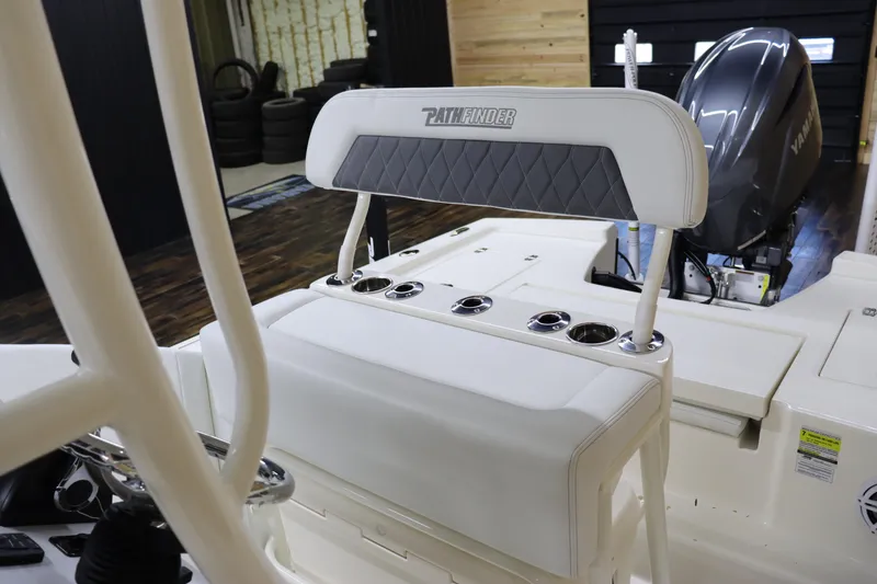 Slide: The Image of 2024 Pathfinder 2200 TRS boat interior with cushioned seating and rod holders. - 11