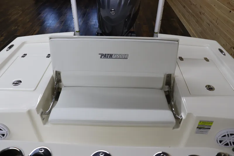 Slide: The Image of 2024 Pathfinder 2200 TRS boat with white seating and motor in background. - 12