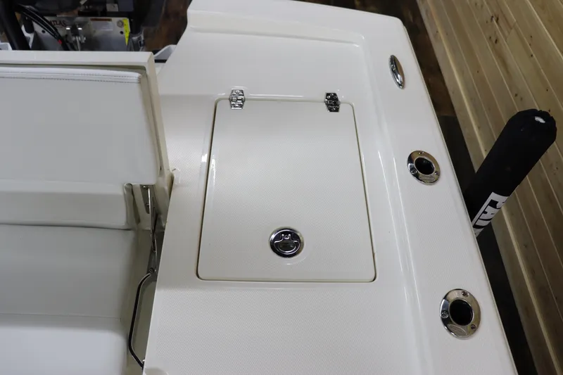 Slide: The Image of 2024 Pathfinder 2200 TRS boat deck with storage compartment and rod holders. - 13