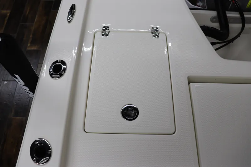 Slide: The Image of 2024 Pathfinder 2200 TRS boat deck with storage compartment and rod holders. - 15