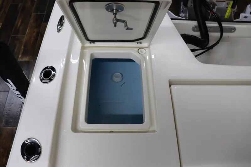 Slide: The Image of 2024 Pathfinder 2200 TRS boat livewell with open lid and faucet. - 16