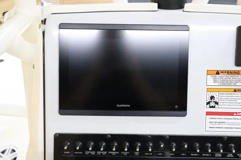 Slide: The Image of 2024 Pathfinder 2200 TRS boat dashboard with Garmin display and control switches. - 19