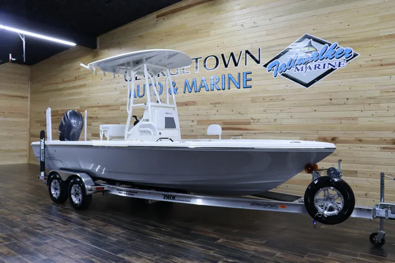 Slide: The Image of 2024 Pathfinder 2200 TRS boat on display at a marine dealership. - 2