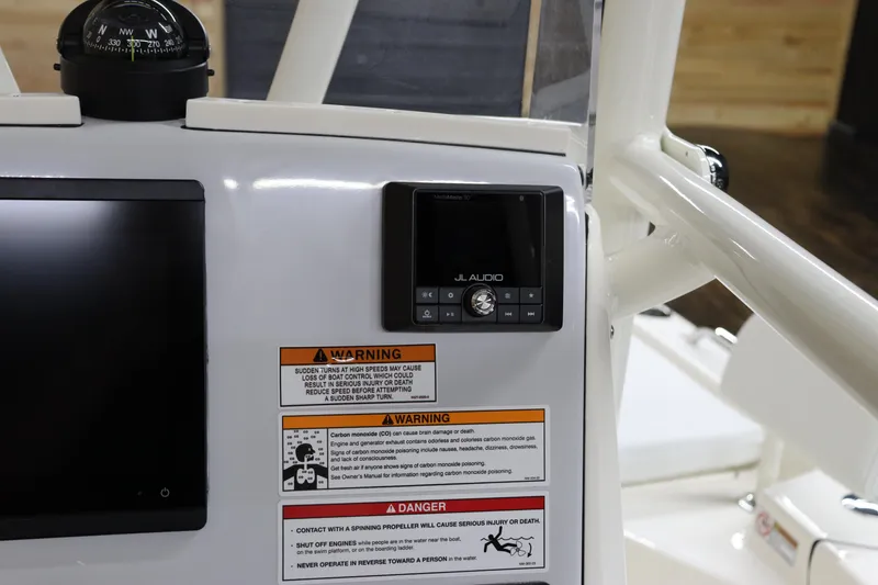 Slide: The Image of 2024 Pathfinder 2200 TRS boat dashboard with JL Audio system and warning labels. - 20