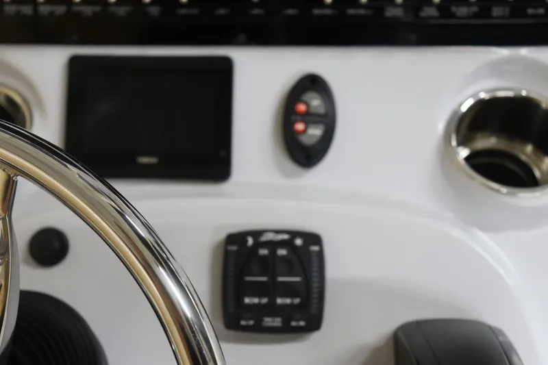 Slide: The Image of Close-up of 2024 Pathfinder 2200 TRS boat dashboard with steering wheel and controls. - 21