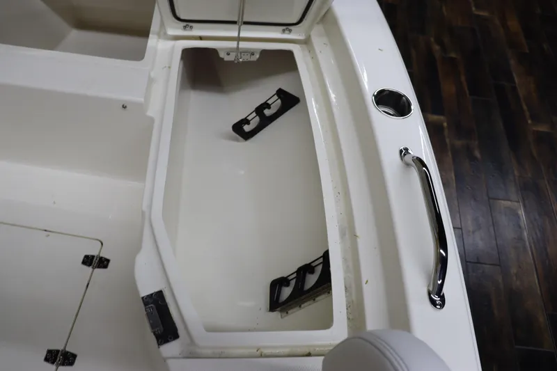 Slide: The Image of 2024 Pathfinder 2200 TRS boat storage compartment with open lid and accessories. - 26