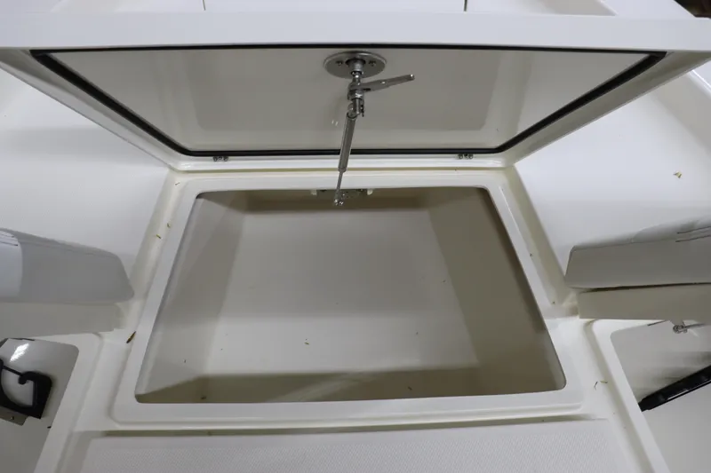 Slide: The Image of 2024 Pathfinder 2200 TRS boat storage compartment with open lid. - 27