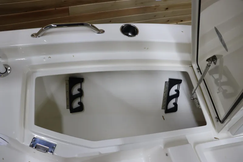 Slide: The Image of 2024 Pathfinder 2200 TRS boat storage compartment with rod holders. - 28