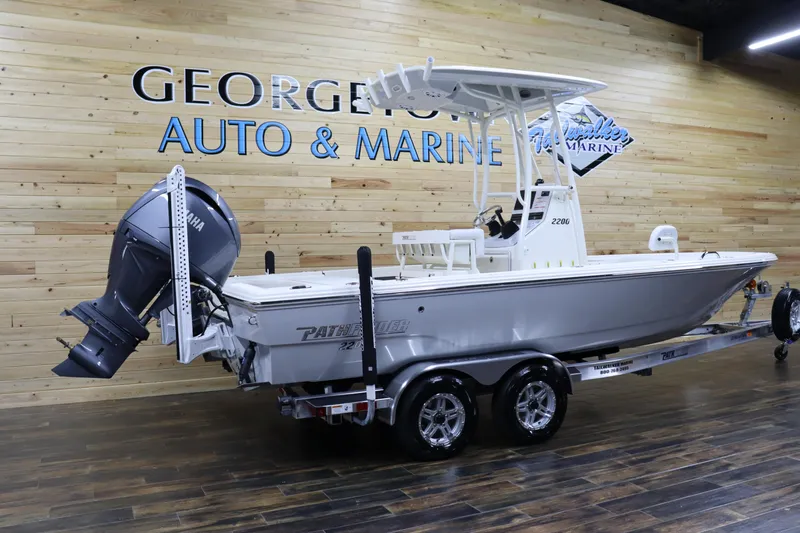 Slide: The Image of 2024 Pathfinder 2200 TRS boat on trailer at George's Auto & Marine showroom. - 3