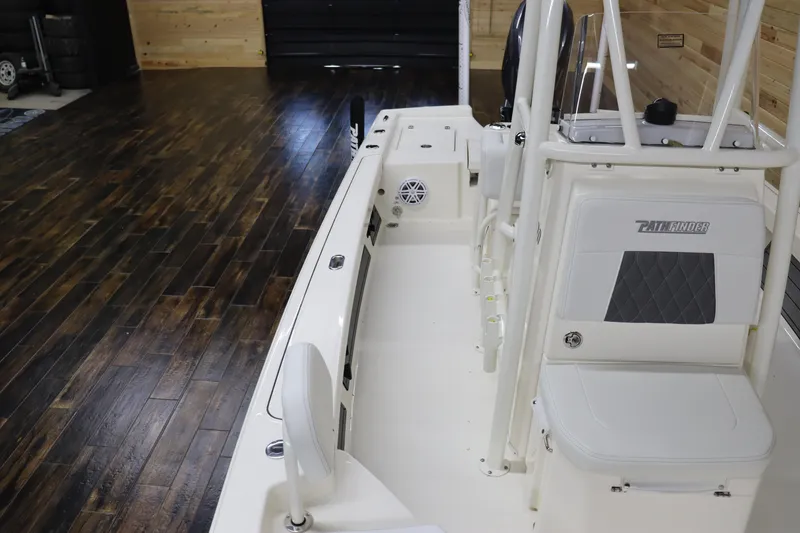Slide: The Image of 2024 Pathfinder 2200 TRS boat interior with white seating and wood flooring. - 8