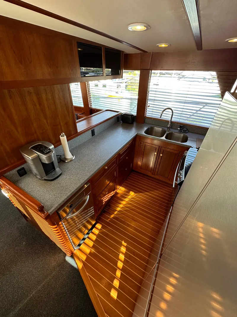 Slide: The Image of 2009 Little Hoquiam 68 Long Range Sportfisher kitchen with modern appliances and wooden cabinetry. - 29