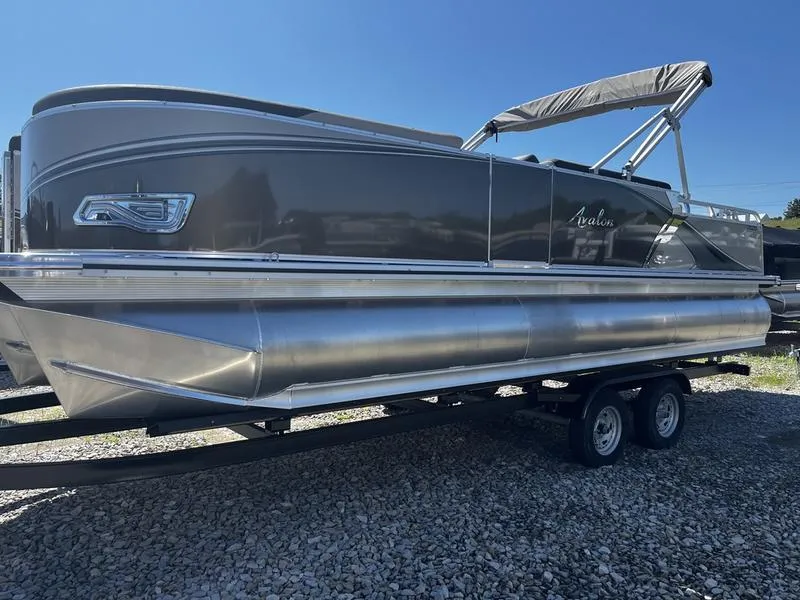 Slide: The Image of 2024 Avalon LSZ ELITE pontoon boat on a trailer, side view. - 0