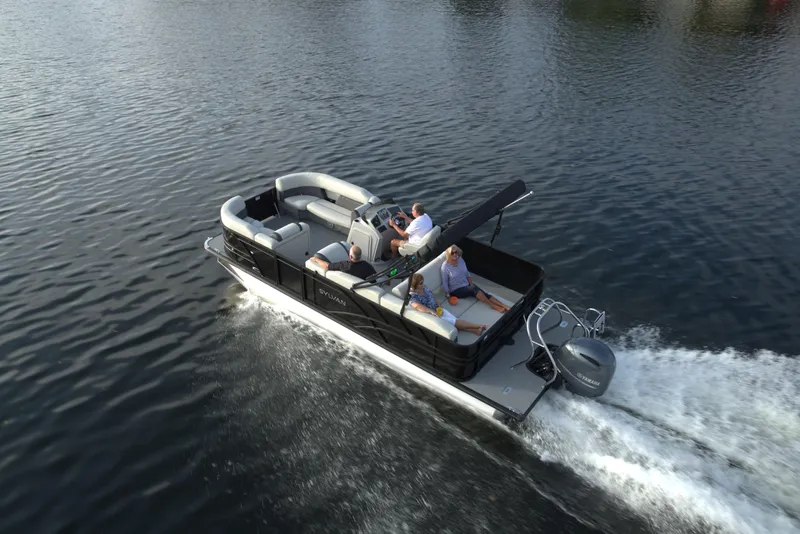 Slide: The Image of 2024 Sylvan Mirage 8522 CLZ pontoon boat cruising on a calm lake. - 10
