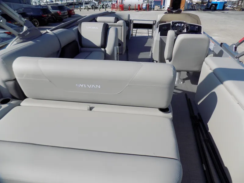 Slide: The Image of 2024 Sylvan Mirage 8522 CLZ pontoon boat interior with gray seating and helm. - 4