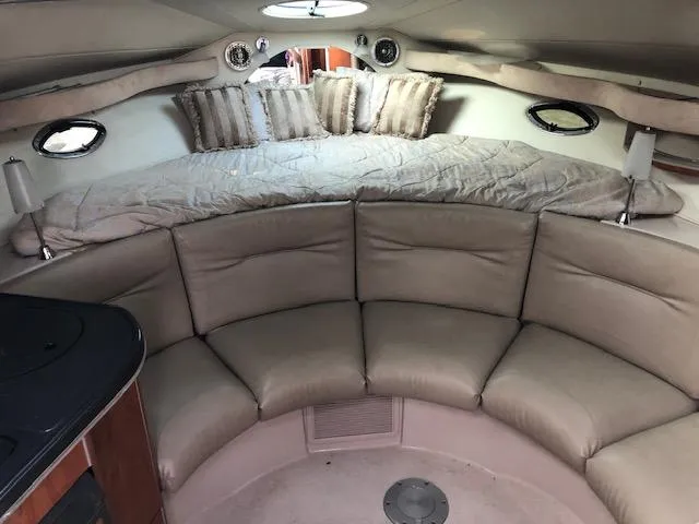 Slide: The Image of 2004 Doral Intrique boat interior with cushioned seating and bed area. - 11