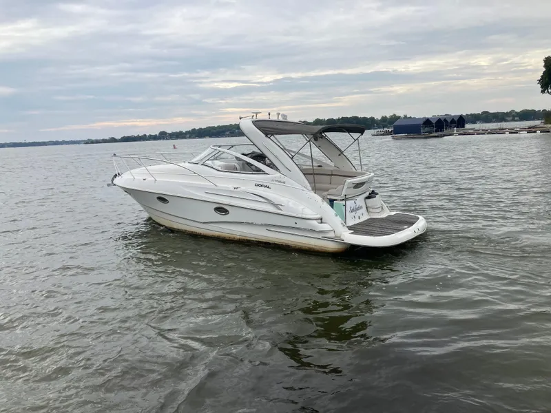 Slide: The Image of 2004 Doral Intrique boat cruising on a lake under a cloudy sky. - 2