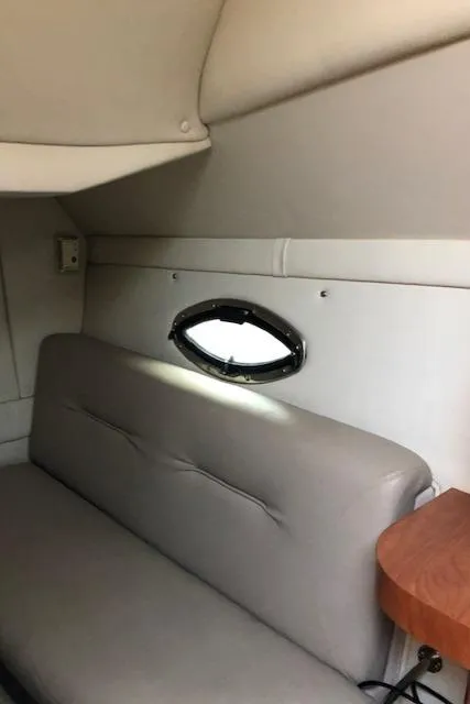 Slide: The Image of Interior cabin of a 2004 Doral Intrique boat with a small window. - 8