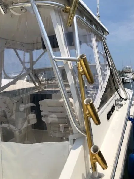 Slide: The Image of 2003 Carolina Classic 25 I/O boat with rod holders and clear enclosure. - 12