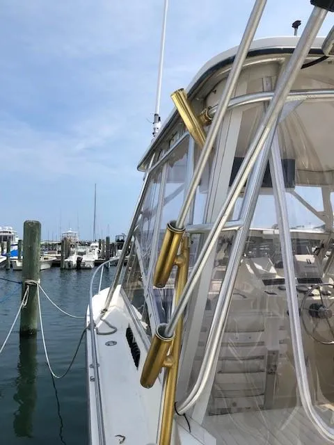 Slide: The Image of 2003 Carolina Classic 25 I/O boat docked at marina, clear skies, side view. - 13