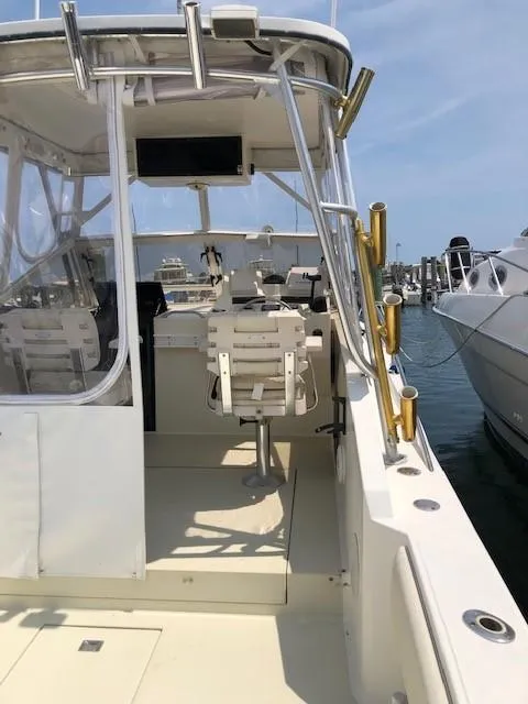 Slide: The Image of 2003 Carolina Classic 25 I/O boat with cockpit view, docked at marina. - 14