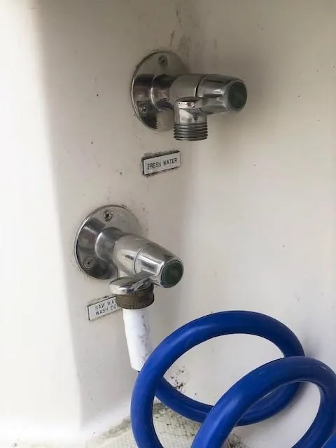 Slide: The Image of Boat water faucets with blue hose, Carolina Classic 25 I/O, 2003 model. - 15