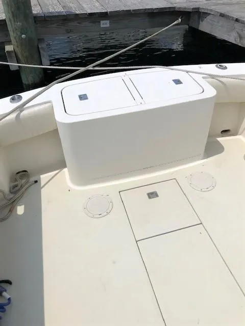 Slide: The Image of 2003 Carolina Classic 25 I/O boat deck, featuring storage compartments and clean design. - 16