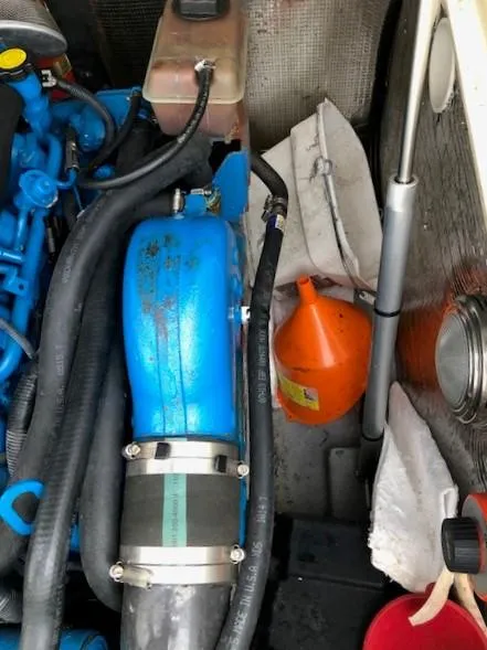 Slide: The Image of Engine compartment of a 2003 Carolina Classic 25 I/O boat with visible hoses and equipment. - 19