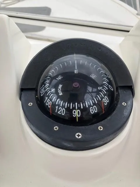 Slide: The Image of Compass on 2003 Carolina Classic 25 I/O boat dashboard, showing navigation directions. - 22