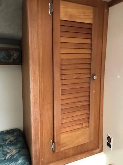 Slide: The Image of Wooden cabinet inside 2003 Carolina Classic 25 I/O boat cabin. - 25
