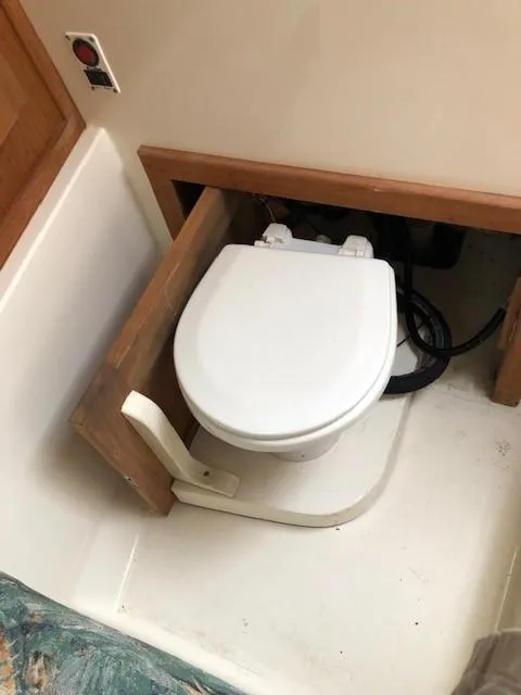 Slide: The Image of 2003 Carolina Classic 25 I/O boat toilet in compact cabin space. - 28