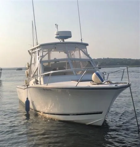 Slide: The Image of 2003 Carolina Classic 25 I/O boat on calm water, front view. - 4