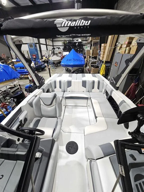Slide: The Image of 2024 Malibu 21 LX-R boat interior in a showroom. - 12