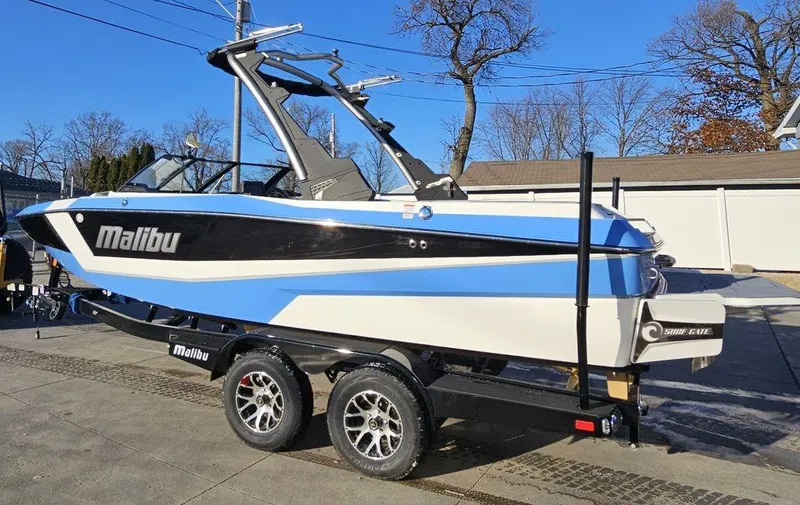 Slide: The Image of 2024 Malibu 21 LX-R boat on trailer, blue and white exterior. - 13