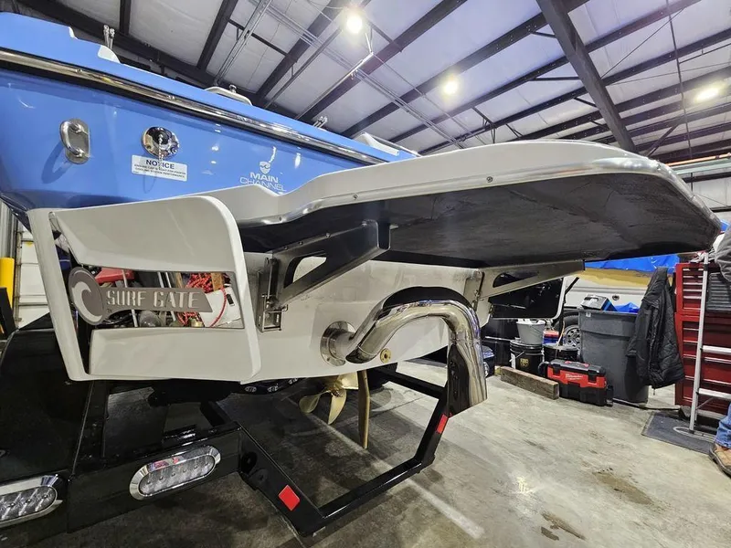 Slide: The Image of 2024 Malibu 21 LX-R boat with Surf Gate system in a warehouse. - 7