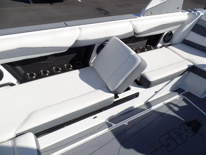 Slide: The Image of 2024 Axis A245 boat interior with white seating and cup holders. - 10