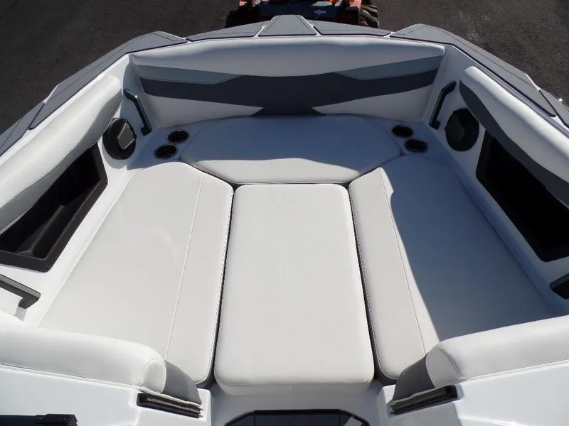 Slide: The Image of 2024 Axis A245 boat interior with white cushioned seating and cup holders. - 20