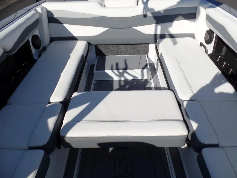 Slide: The Image of 2024 Axis A245 boat interior with white cushioned seating and sleek design. - 6