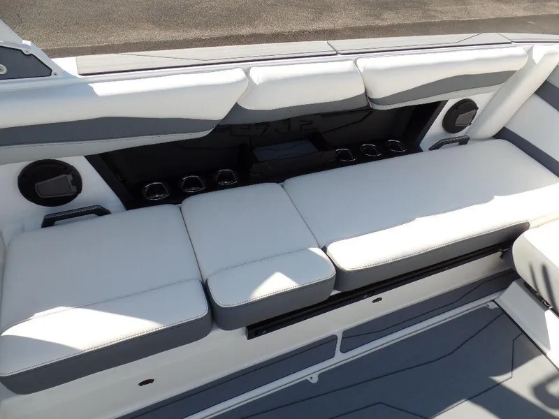Slide: The Image of 2024 Axis A245 boat interior with white cushioned seating and cup holders. - 7