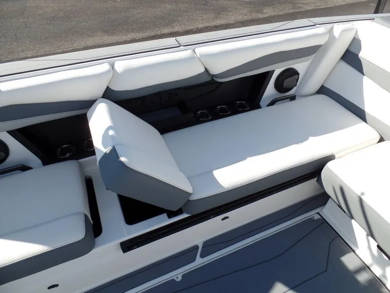 Slide: The Image of 2024 Axis A245 boat interior with white and gray seating and cup holders. - 8