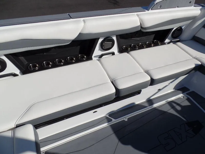 Slide: The Image of 2024 Axis A245 boat interior with white cushioned seating and cup holders. - 9