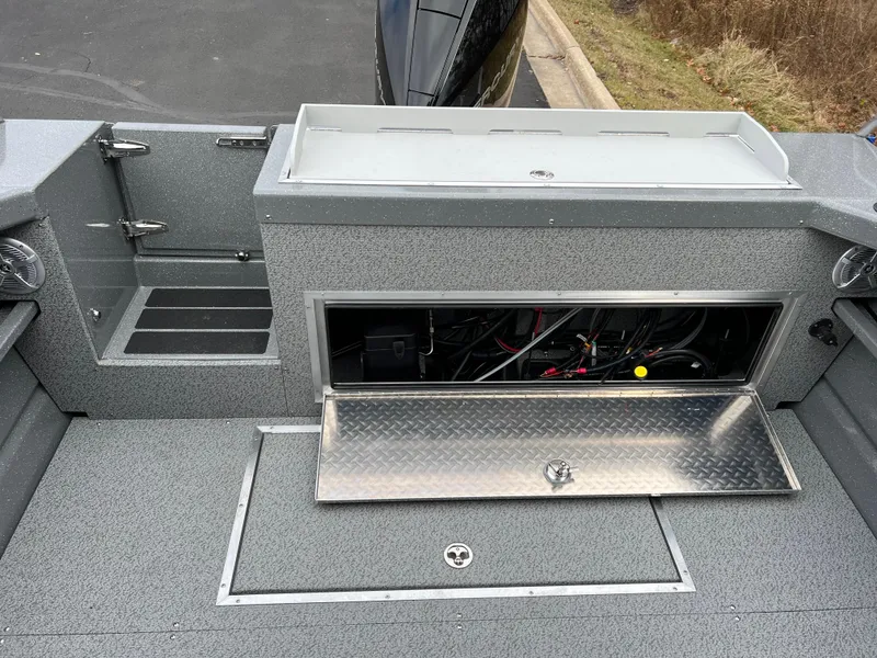 Slide: The Image of 2024 Spartan 215 Athens boat interior with open storage compartments. - 11