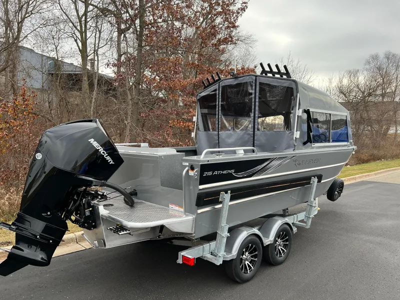 Slide: The Image of 2024 Spartan 215 Athens boat on a trailer with Mercury outboard motor. - 2