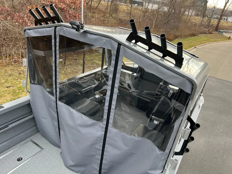 Slide: The Image of 2024 Spartan 215 Athens boat with enclosed cabin and rod holders. - 3