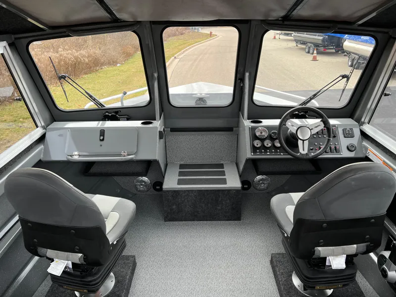 Slide: The Image of 2024 Spartan 215 Athens boat interior with dual seats and control panel. - 4